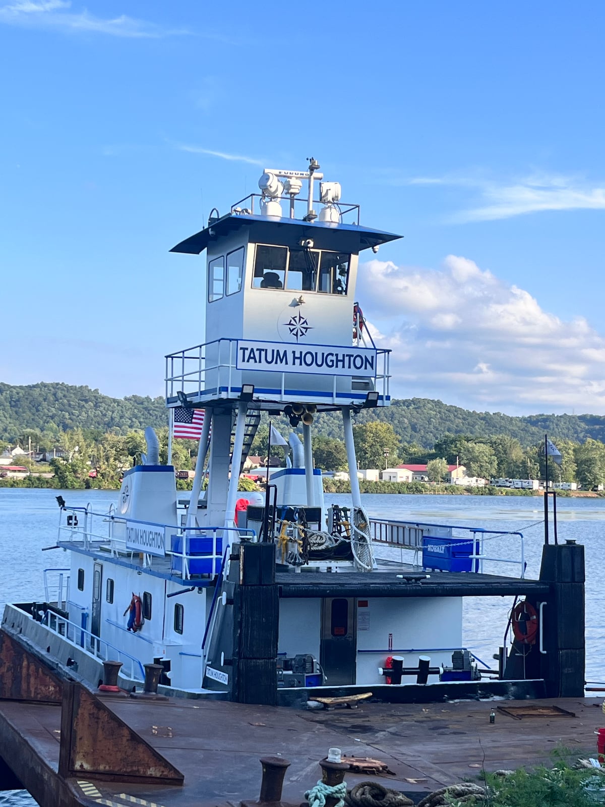 A bow-on view of Tatum Houghton at its mooring, showing the tall pilothouse and forward deck.